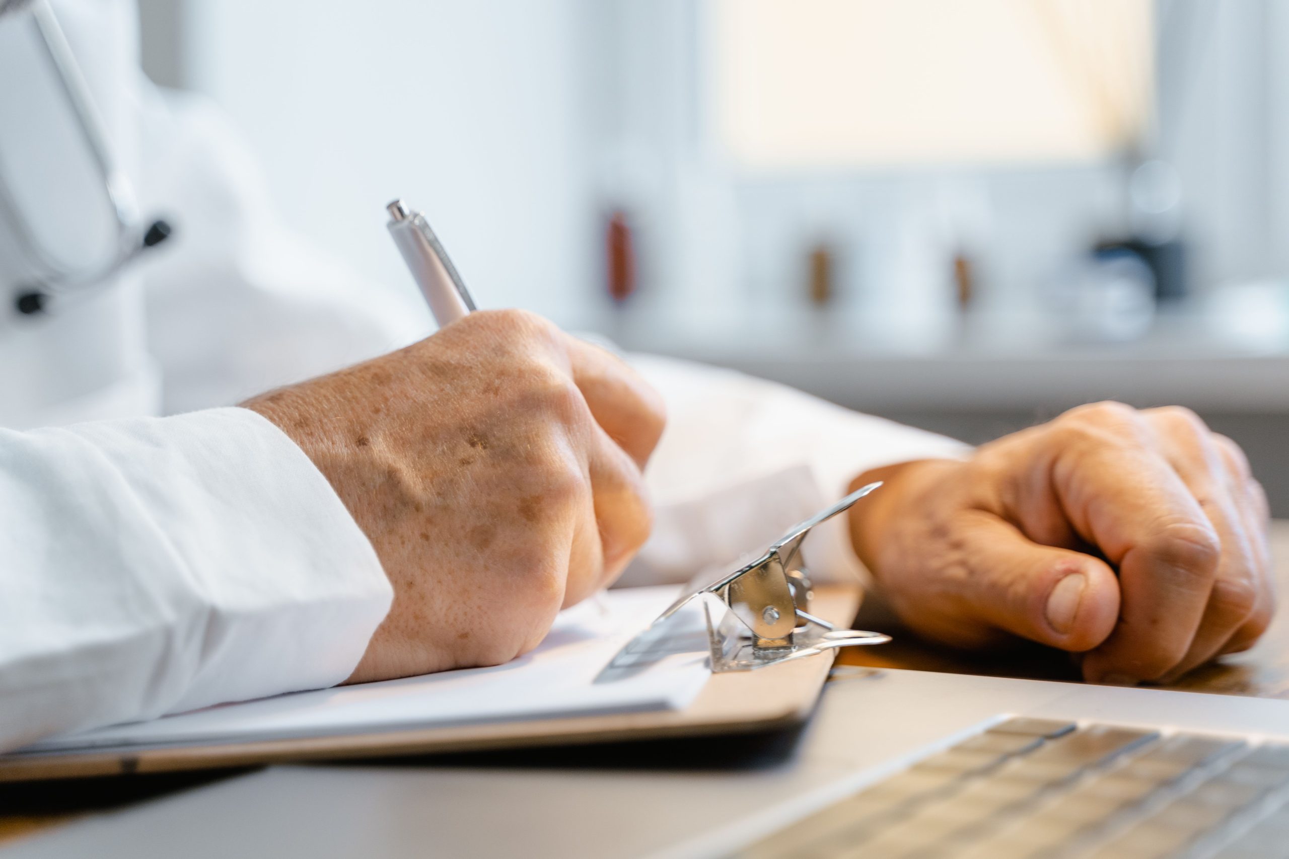 Docteur écrivant sur un bloc-notes en bureau